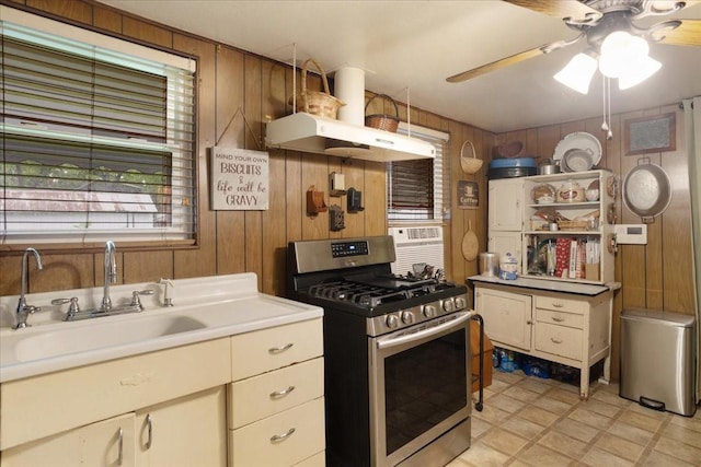 1231 W Woodard St, Denison, TX 75020 - kitchen with stainless steel range with gas cooktop, wooden walls, a sink, a ceiling fan, and open shelves