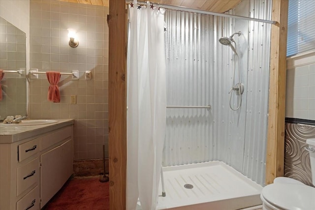 1231 W Woodard St, Denison, TX 75020 - full bath featuring a stall shower, tile walls, vanity, and toilet