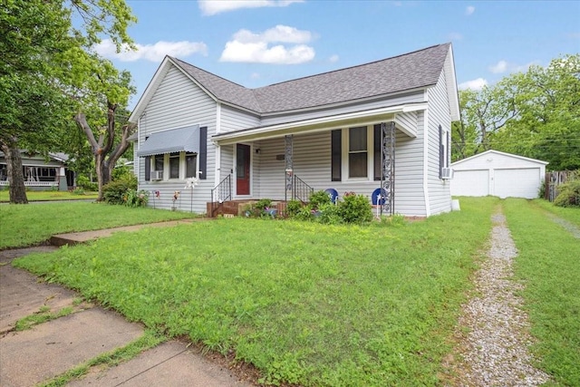 1231 W Woodard St, Denison, TX 75020 - view of front of property featuring a shingled roof, a front yard, covered porch, an outbuilding, and a detached garage