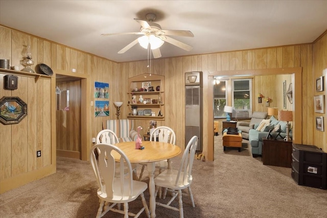 1231 W Woodard St, Denison, TX 75020 - dining area featuring carpet flooring, wooden walls, and a ceiling fan
