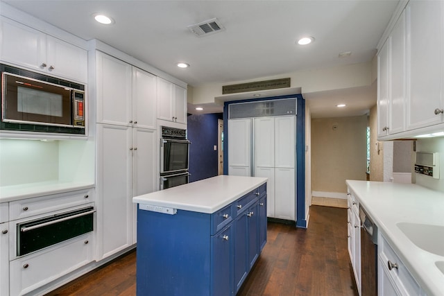 410 E Beady Rd, Arlington, TX 76006 - kitchen featuring blue cabinetry, a warming drawer, built in microwave, white cabinets, and dishwasher