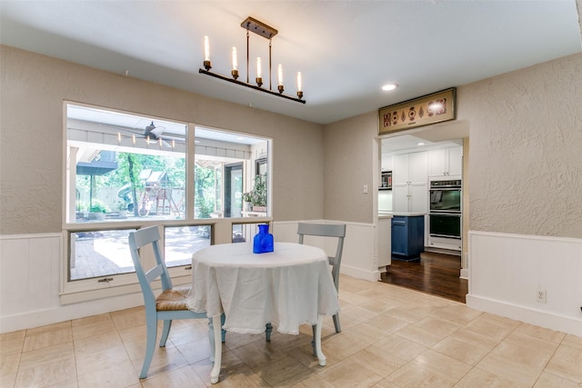 410 E Beady Rd, Arlington, TX 76006 - dining area with a textured wall, wainscoting, a decorative wall, and ceiling fan
