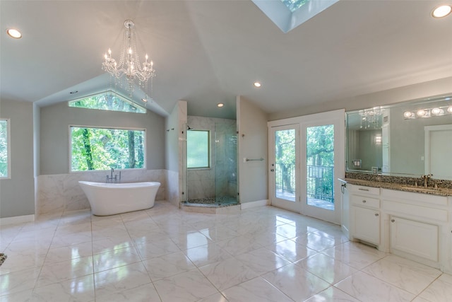 410 E Beady Rd, Arlington, TX 76006 - bathroom featuring lofted ceiling, marble finish floors, a stall shower, vanity, and a freestanding tub