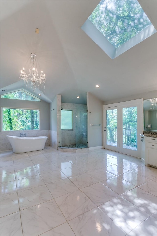 410 E Beady Rd, Arlington, TX 76006 - bathroom featuring a chandelier, lofted ceiling, a stall shower, a soaking tub, and vanity