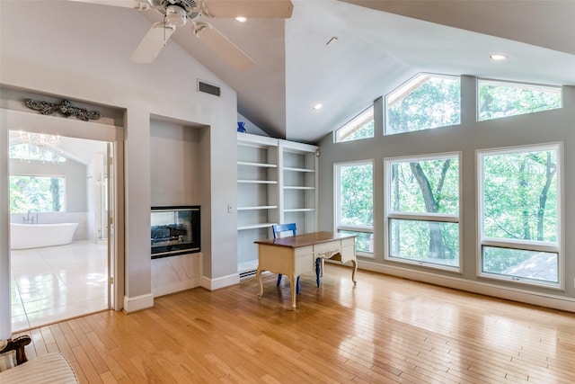 410 E Beady Rd, Arlington, TX 76006 - office featuring healthy amount of natural light, light wood-style flooring, vaulted ceiling, a multi sided fireplace, and a ceiling fan