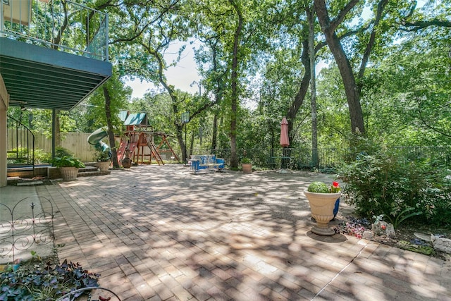 410 E Beady Rd, Arlington, TX 76006 - wooden terrace featuring a playground, a fenced backyard, and a patio