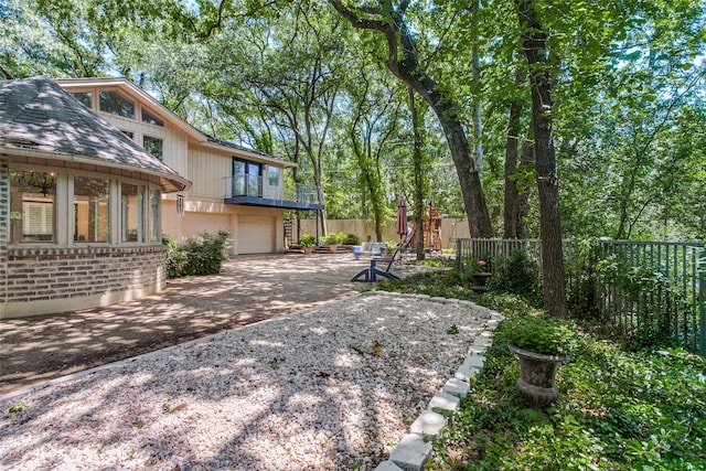 410 E Beady Rd, Arlington, TX 76006 - view of yard featuring a garage, driveway, and a balcony