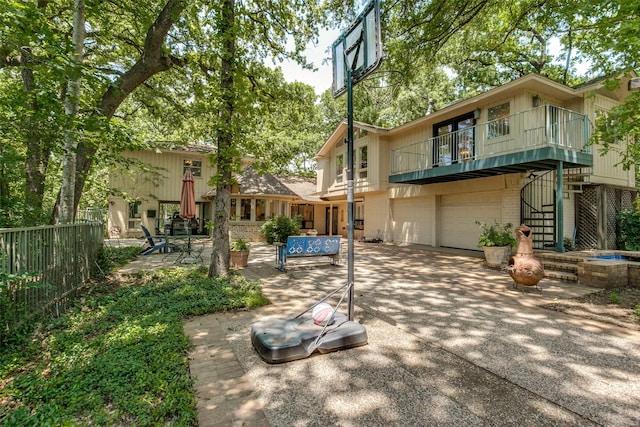 410 E Beady Rd, Arlington, TX 76006 - back of property featuring a balcony, a garage, stairs, driveway, and brick siding