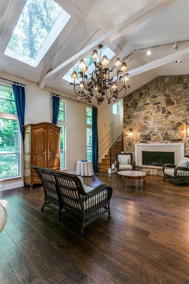 410 E Beady Rd, Arlington, TX 76006 - living area with a chandelier, a skylight, wood finished floors, a fireplace, and stairway