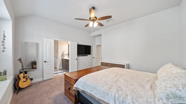 bedroom featuring carpet flooring, vaulted ceiling, baseboards, a ceiling fan, and ensuite bathroom