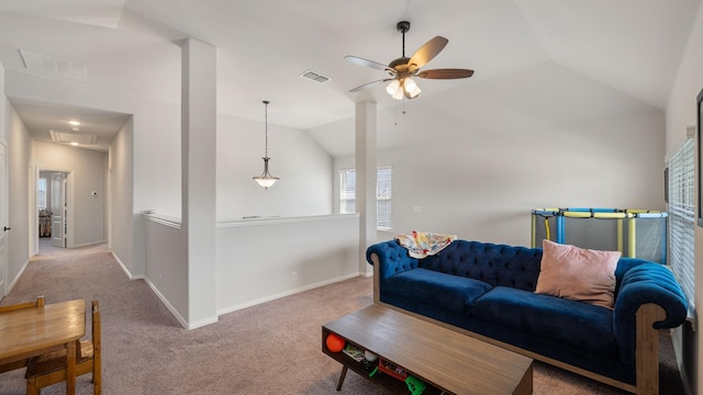living area with a ceiling fan, attic access, carpet floors, vaulted ceiling, and baseboards
