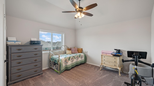 bedroom with vaulted ceiling, baseboards, dark carpet, and ceiling fan