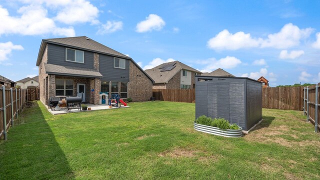 back of property featuring a patio, a shed, an outdoor structure, and brick siding