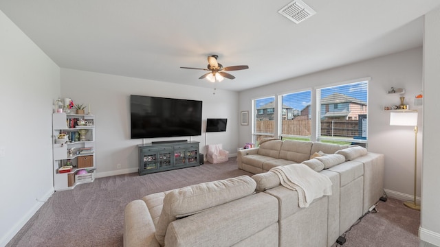 living room featuring ceiling fan, carpet, and baseboards