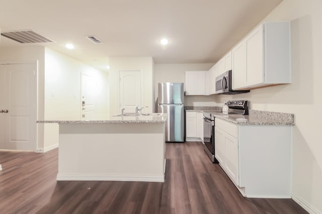 510 E Shepherd St, Denison, TX 75021 - kitchen with stainless steel appliances, dark wood-style floors, white cabinetry, light stone counters, and recessed lighting