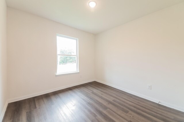 510 E Shepherd St, Denison, TX 75021 - spare room with dark wood-style flooring and baseboards