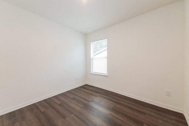 510 E Shepherd St, Denison, TX 75021 - spare room featuring dark wood-type flooring and baseboards