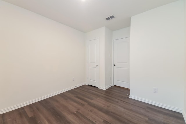 510 E Shepherd St, Denison, TX 75021 - unfurnished bedroom with dark wood-style flooring and baseboards