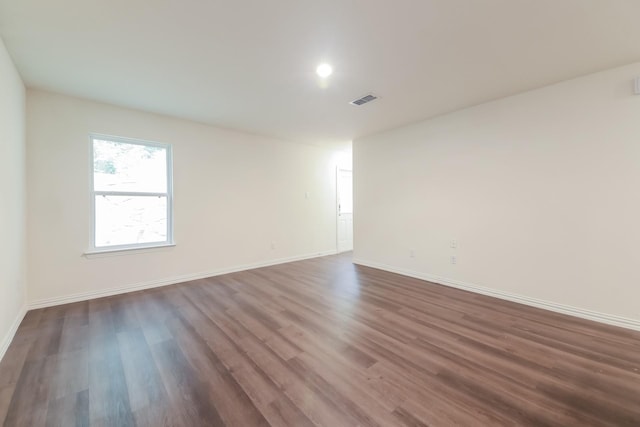 510 E Shepherd St, Denison, TX 75021 - spare room featuring dark wood-style flooring and baseboards