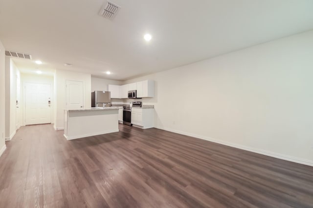 510 E Shepherd St, Denison, TX 75021 - unfurnished living room with baseboards, dark wood-style floors, and recessed lighting