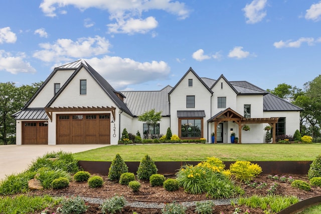 1210 Emerald Sound Blvd, Oak Point, TX 75068 - modern farmhouse style home featuring a standing seam roof, metal roof, a front lawn, and concrete driveway