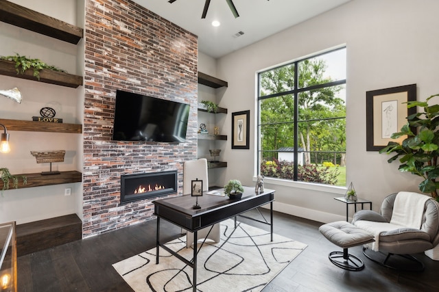 1210 Emerald Sound Blvd, Oak Point, TX 75068 - living area with a brick fireplace, wood finished floors, ceiling fan, baseboards, and built in shelves