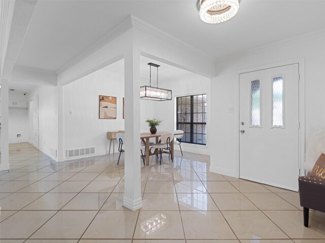 3804 Chestnut St, Fort Worth, TX 76137 - entryway with a chandelier, crown molding, light tile patterned floors, and baseboards
