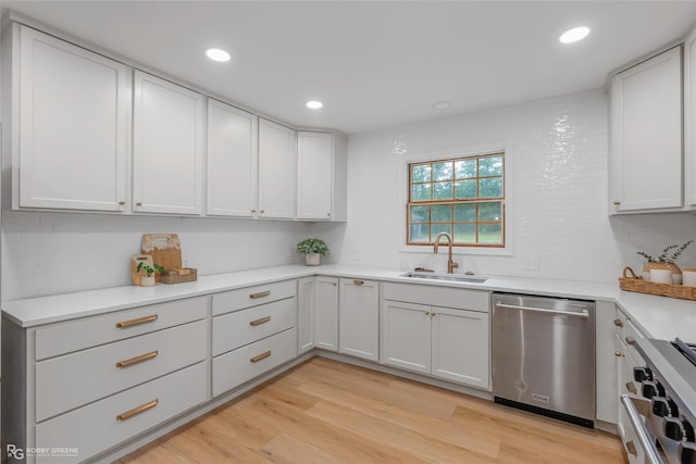 4131 Waller Dr, Shreveport, LA 71119 - kitchen featuring stainless steel appliances, a sink, light wood-style floors, light countertops, and recessed lighting