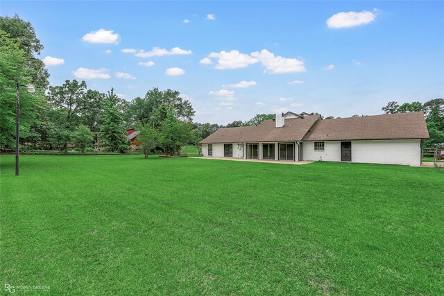 4131 Waller Dr, Shreveport, LA 71119 - back of property with a yard and a patio