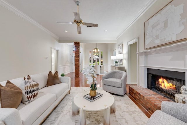 907 Sunpoint Cir, Rockwall, TX 75087 - living room with ornamental molding, a chandelier, ceiling fan, a fireplace, and light wood-type flooring