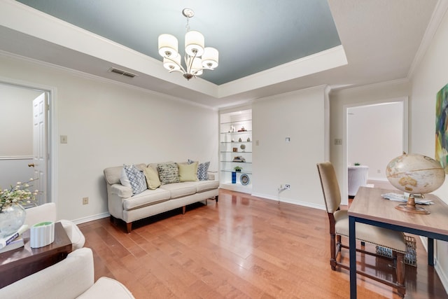 907 Sunpoint Cir, Rockwall, TX 75087 - living area featuring a chandelier, light wood finished floors, ornamental molding, a tray ceiling, and baseboards