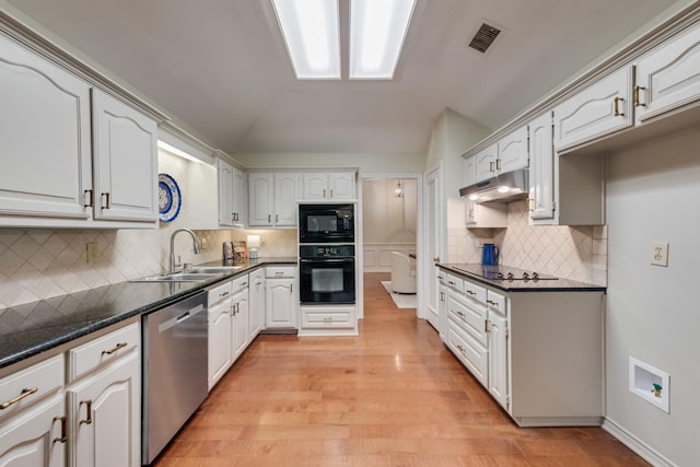 907 Sunpoint Cir, Rockwall, TX 75087 - kitchen featuring black appliances, a sink, dark countertops, decorative backsplash, and under cabinet range hood