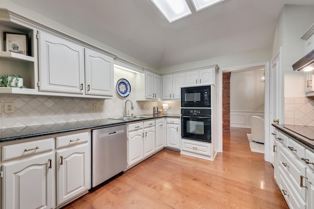 907 Sunpoint Cir, Rockwall, TX 75087 - kitchen with black appliances, open shelves, dark countertops, light wood-style floors, and wainscoting