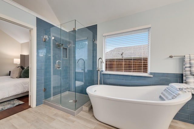 907 Sunpoint Cir, Rockwall, TX 75087 - full bath featuring a freestanding bath, a stall shower, wood finished floors, vaulted ceiling, and ensuite bath