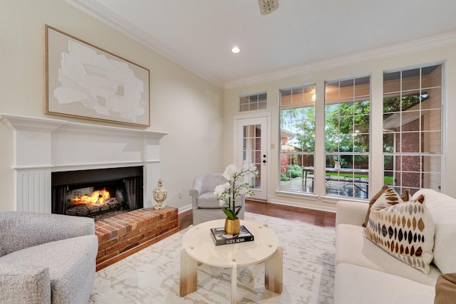 907 Sunpoint Cir, Rockwall, TX 75087 - living area featuring crown molding, wood finished floors, a brick fireplace, recessed lighting, and baseboards