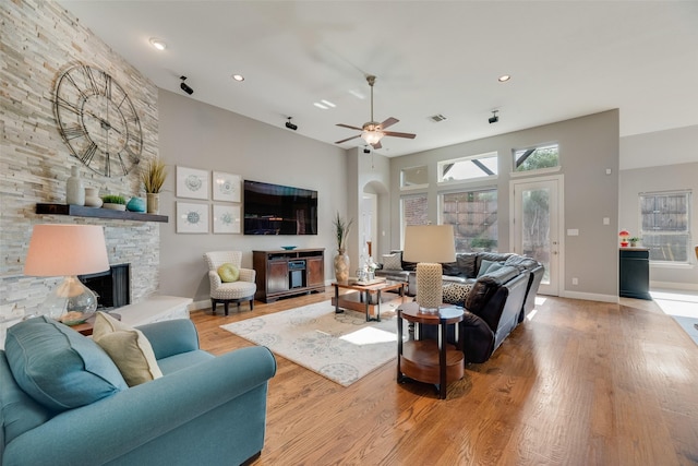 106 Magnolia Ln, Hickory Creek, TX 75065 - living area featuring a fireplace, wood finished floors, a ceiling fan, baseboards, and recessed lighting