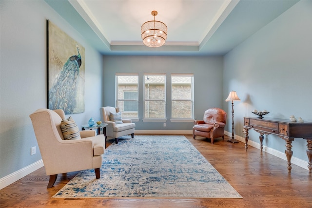 106 Magnolia Ln, Hickory Creek, TX 75065 - living area featuring a chandelier, a raised ceiling, wood finished floors, and baseboards