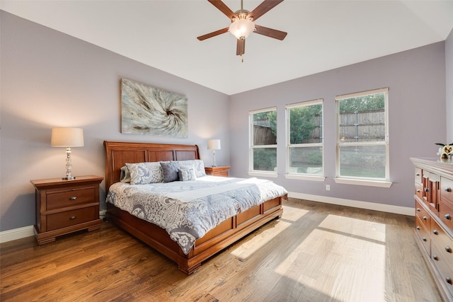 106 Magnolia Ln, Hickory Creek, TX 75065 - bedroom with baseboards, wood finished floors, vaulted ceiling, and ceiling fan