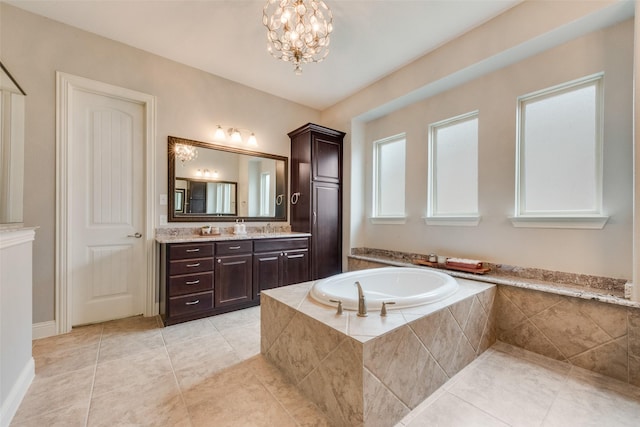 full bath with a bath, vanity, tile patterned flooring, and a chandelier