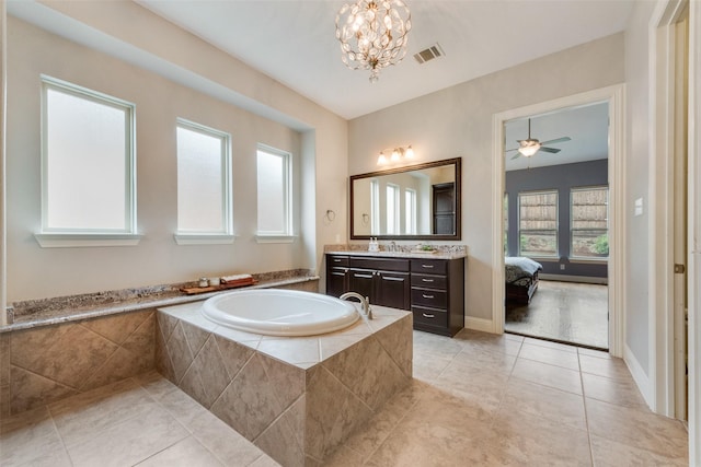 full bathroom featuring tile patterned flooring, a garden tub, vanity, a chandelier, and connected bathroom