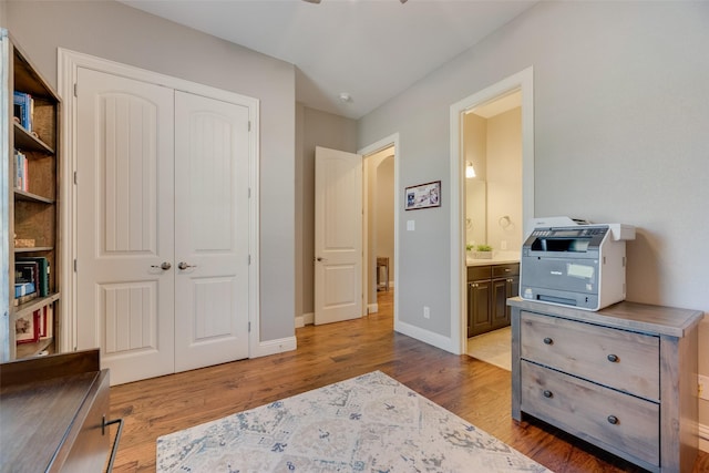 106 Magnolia Ln, Hickory Creek, TX 75065 - bedroom featuring a closet, wood finished floors, baseboards, and connected bathroom
