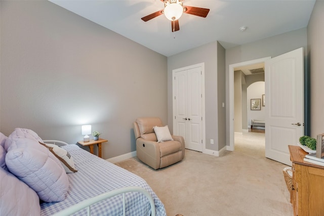 106 Magnolia Ln, Hickory Creek, TX 75065 - bedroom featuring light carpet, baseboards, arched walkways, a closet, and a ceiling fan