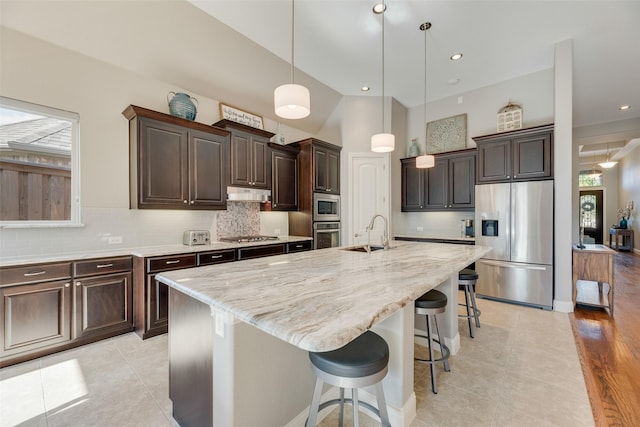 106 Magnolia Ln, Hickory Creek, TX 75065 - kitchen with stainless steel appliances, healthy amount of natural light, dark brown cabinets, decorative backsplash, and recessed lighting