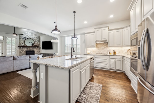 5400 Fringetree Dr, Mckinney, TX 75071 - kitchen with a sink, stainless steel appliances, healthy amount of natural light, a fireplace, and recessed lighting