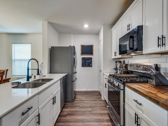 14340 Cloudview Way, Fort Worth, TX 76052 - kitchen with stainless steel appliances, a sink, butcher block countertops, dark wood-style flooring, and white cabinets