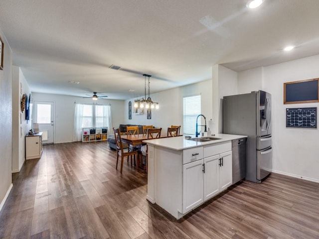 14340 Cloudview Way, Fort Worth, TX 76052 - kitchen featuring a sink, appliances with stainless steel finishes, dark wood-style floors, white cabinetry, and recessed lighting