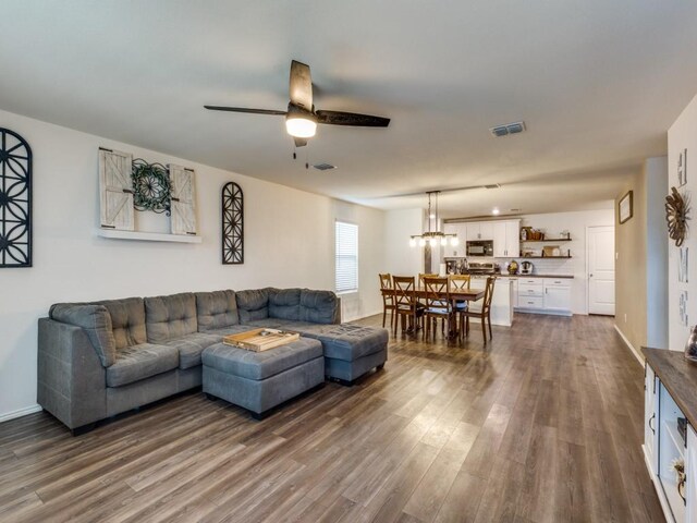 14340 Cloudview Way, Fort Worth, TX 76052 - living area featuring dark wood-style flooring, a ceiling fan, and a chandelier