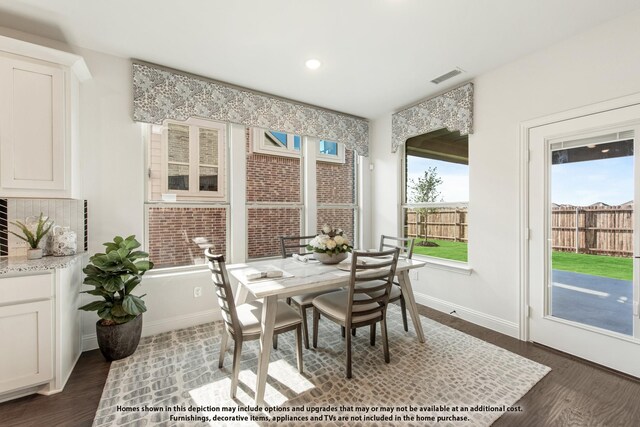 dining room featuring dark wood-type flooring, baseboards, and recessed lighting