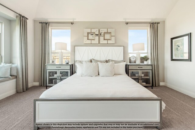 carpeted bedroom with baseboards, multiple windows, and lofted ceiling