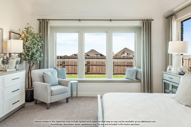 bedroom featuring light carpet and baseboards